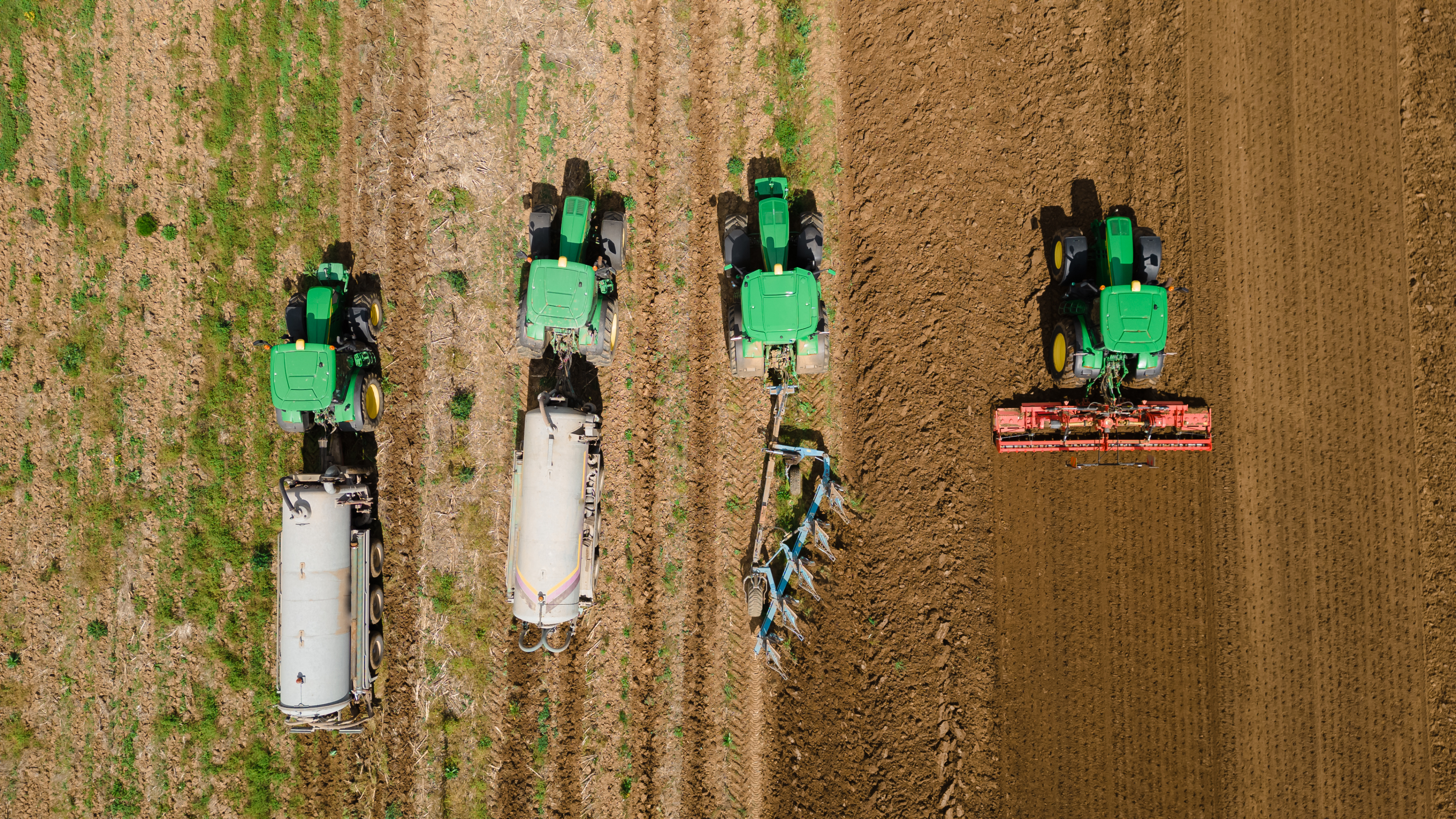 Tractors working seamlessly in unison exemplifies the spirit of rural life, where farm equipment and farming machinery are crucial components in achieving agricultural profitability and sustaining the farming industry for future generations.