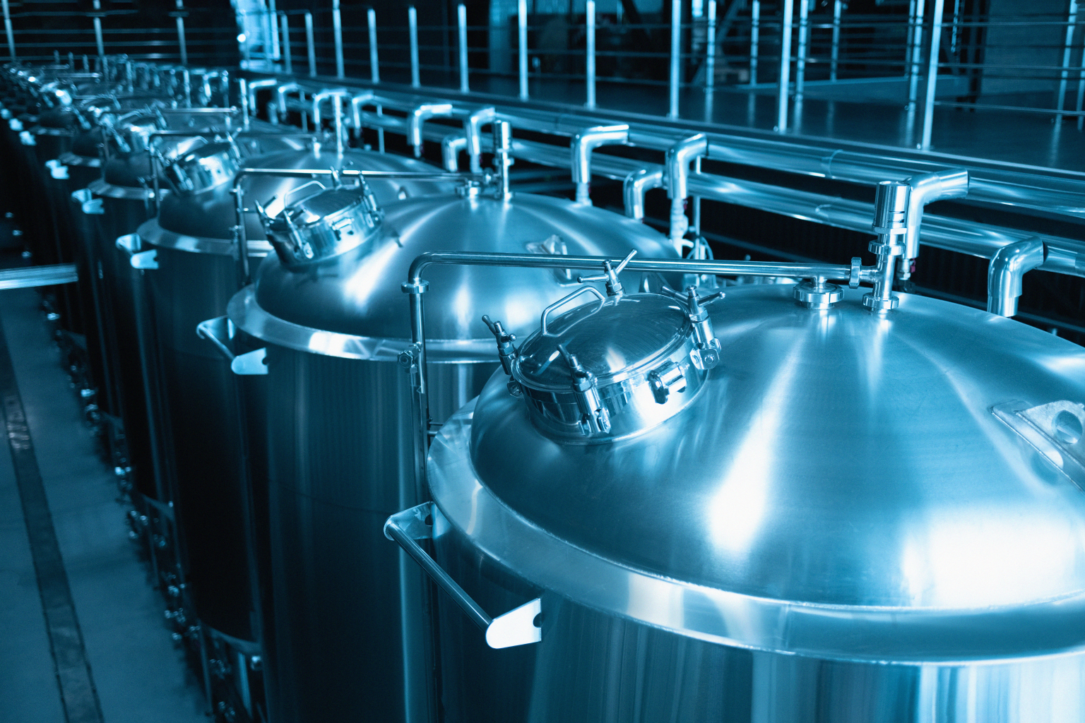 Private microbrewery. Modern beer plant with brewering kettles, tubes and tanks made of stainless steel